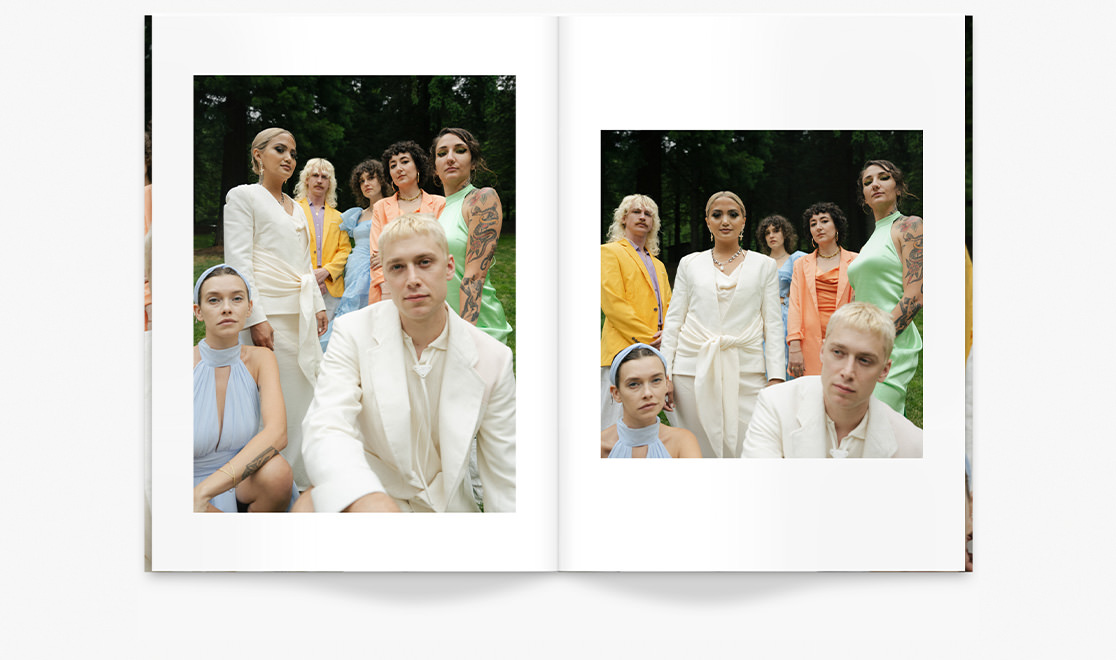 Open portrait wedding magazine with photos of bridal party staring at camera wearing white and pastel shades