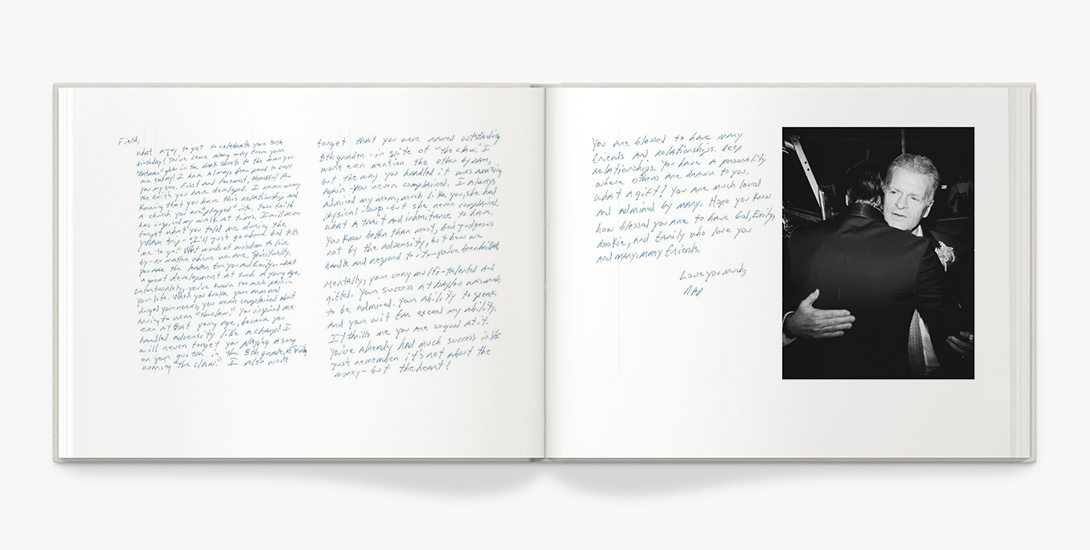 Photo book with handwritten text and black and white portrait of two men hugging.