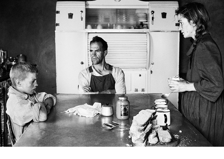 David Goldblatt black and white photography of family at kitchen table.