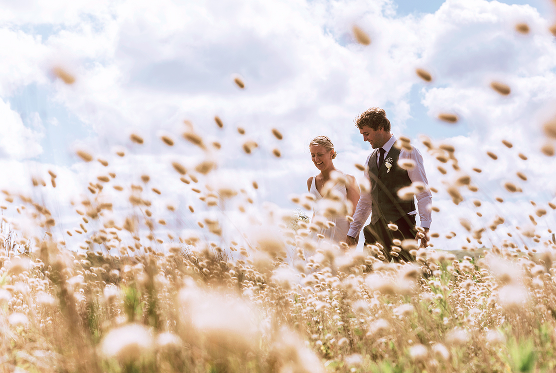couple on wedding day in the grass.