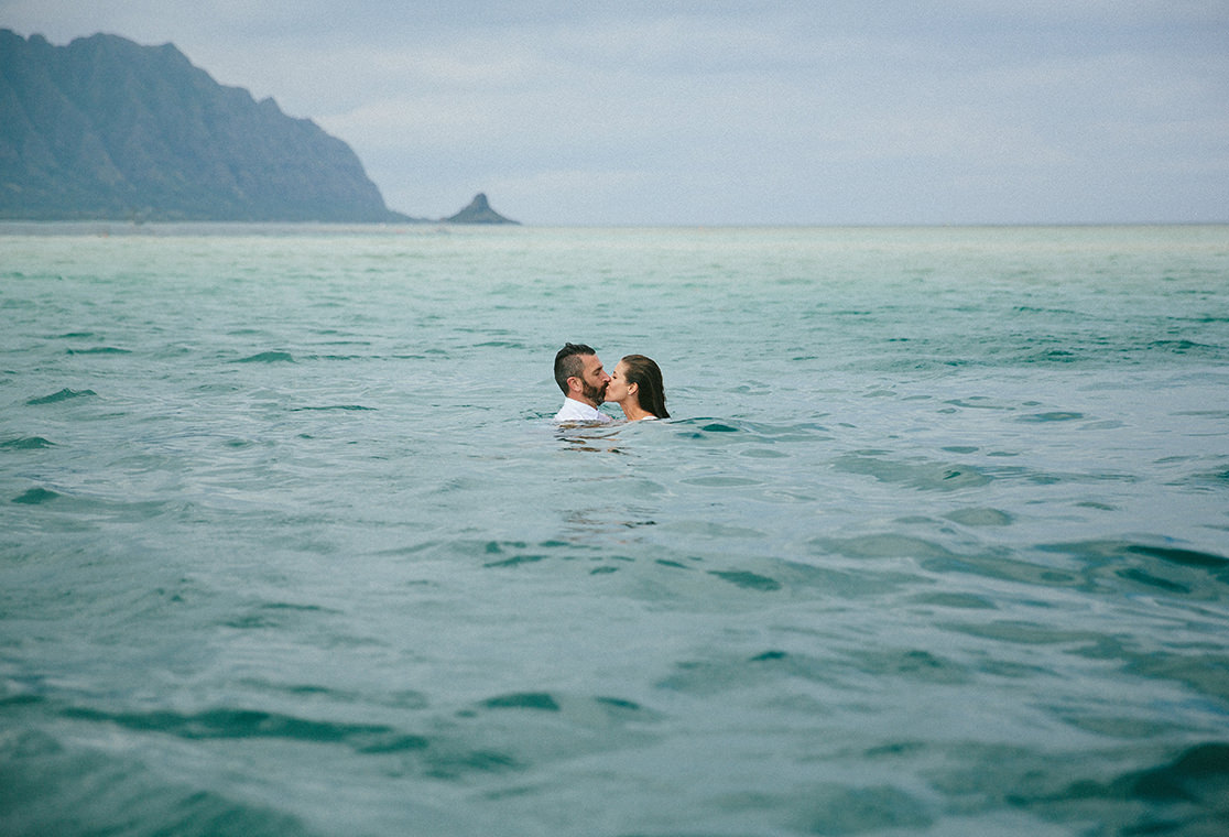 Couple in deep water kissing.