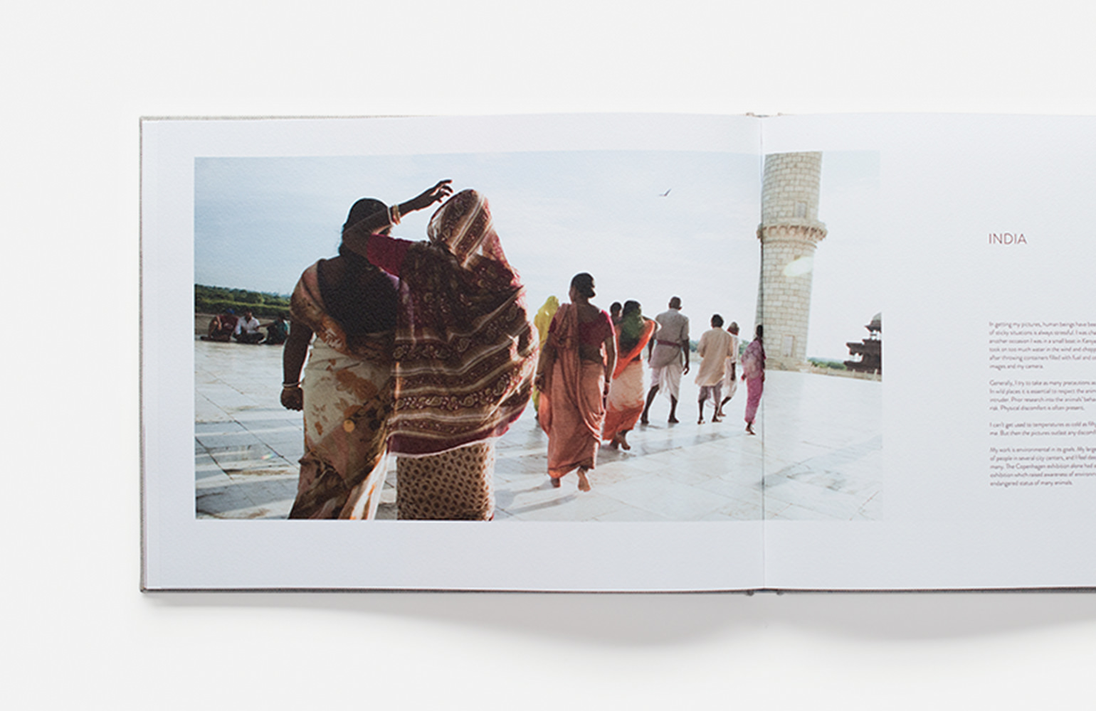 Open photo book with image of travels from India