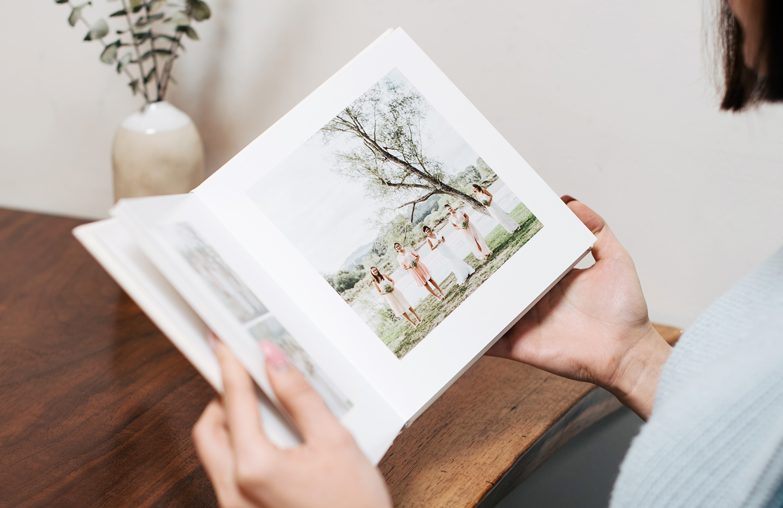 Person looking at square medium wedding Photo Album.