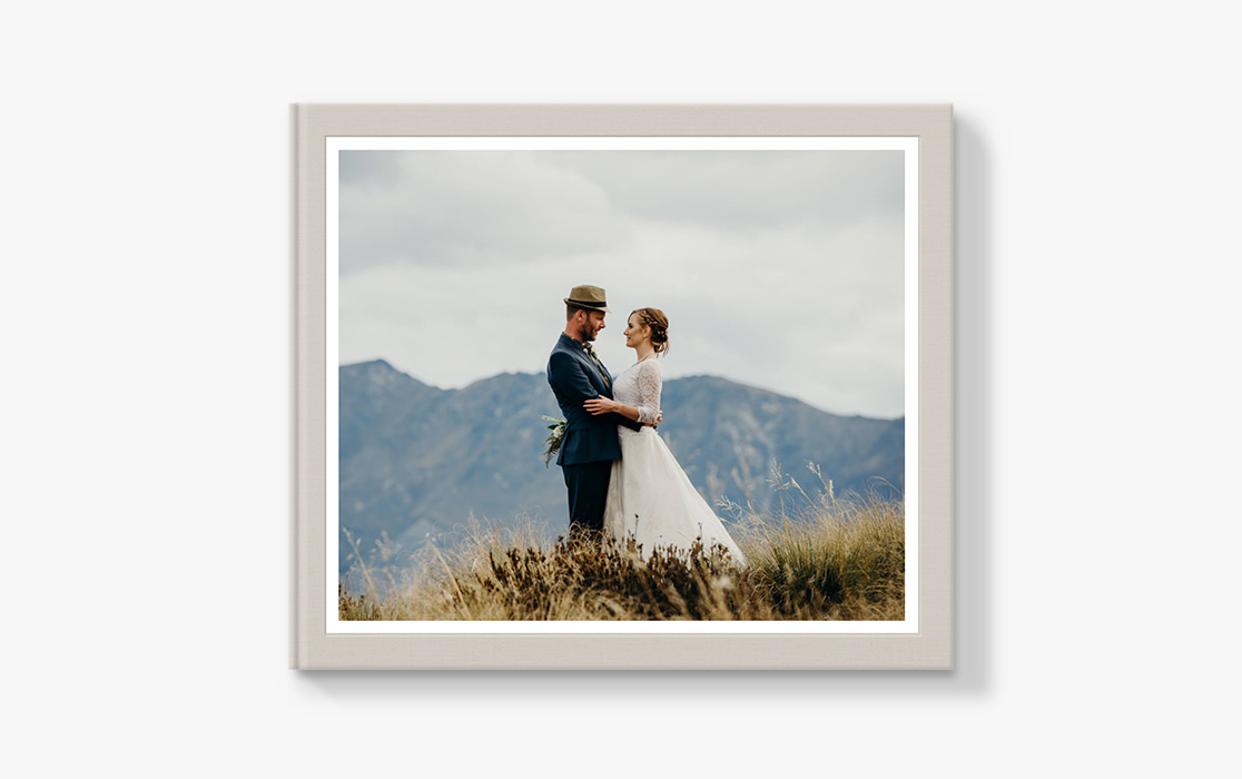 Photo book with newlyweds on a mountain.