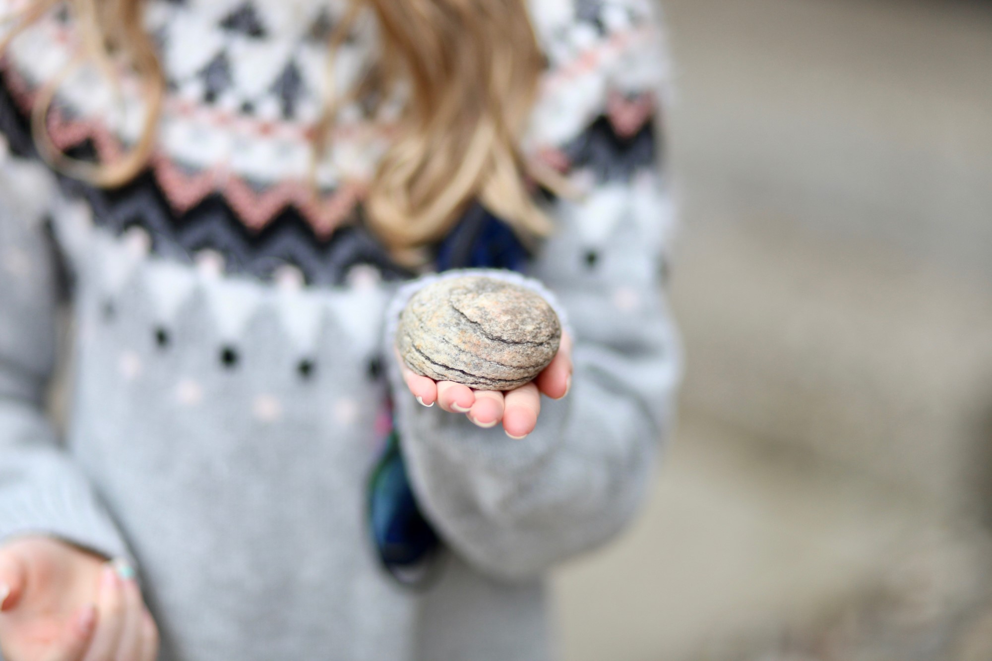 Girl holding rock.