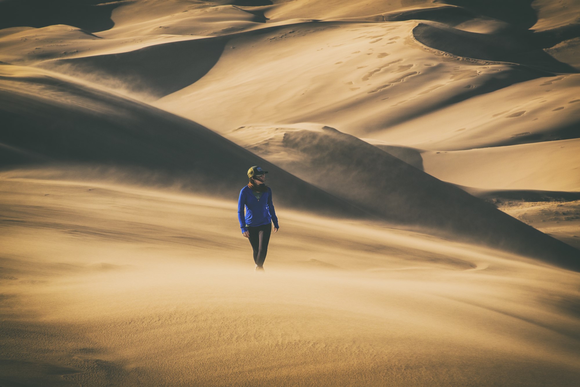 Female walking through desert landscape.