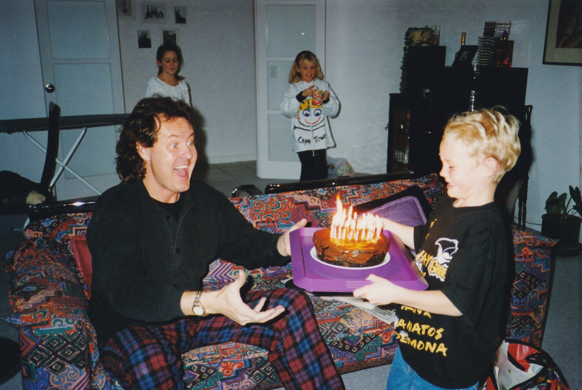 Boy giving his dad a birthday cake.