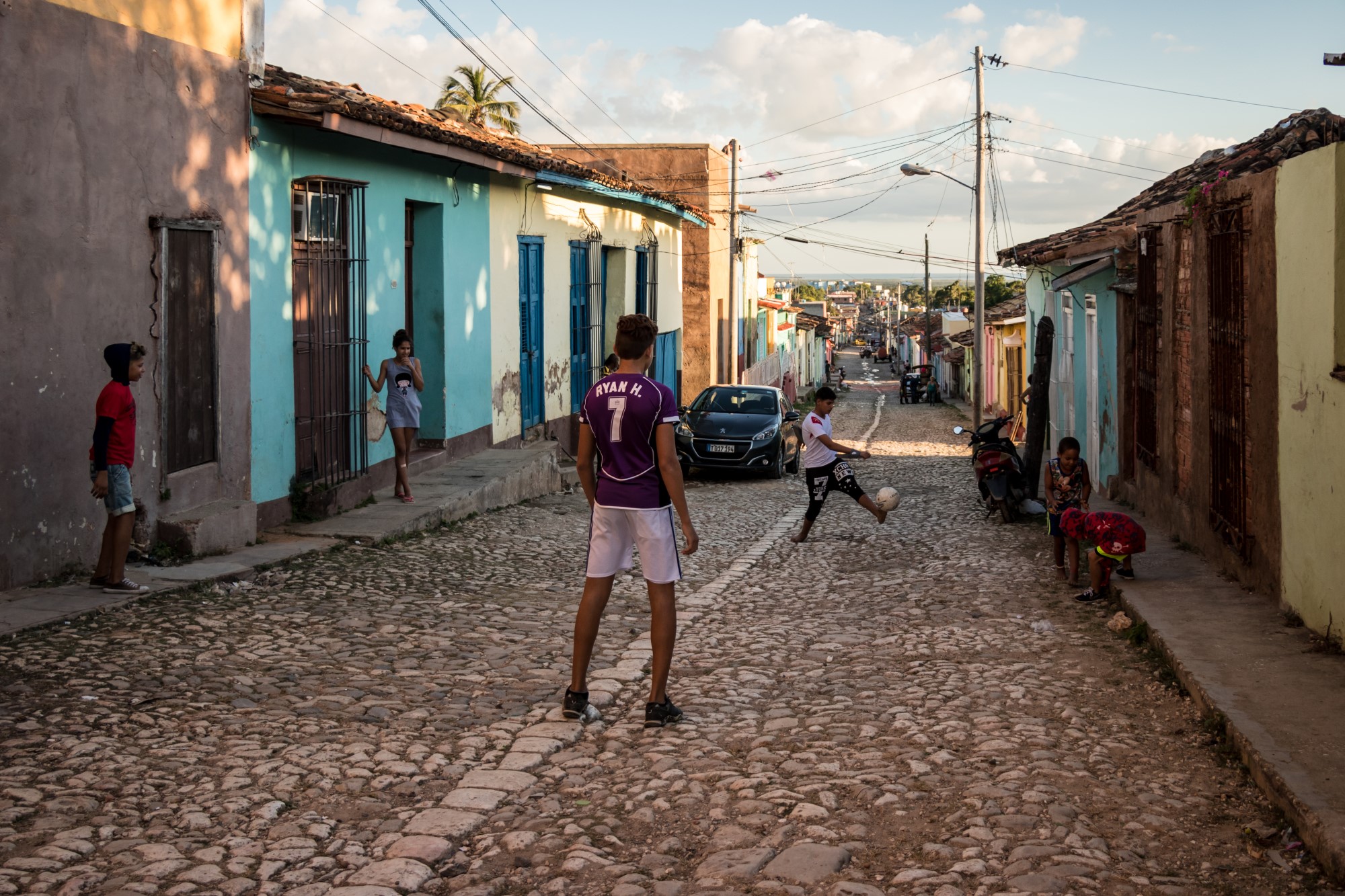 Kids playing football in street of Cuba.