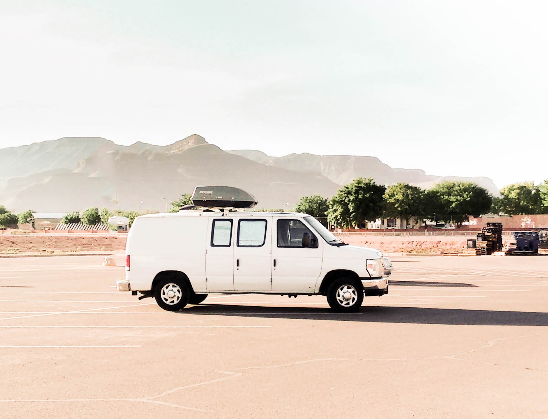 White van in an empty parking lot.