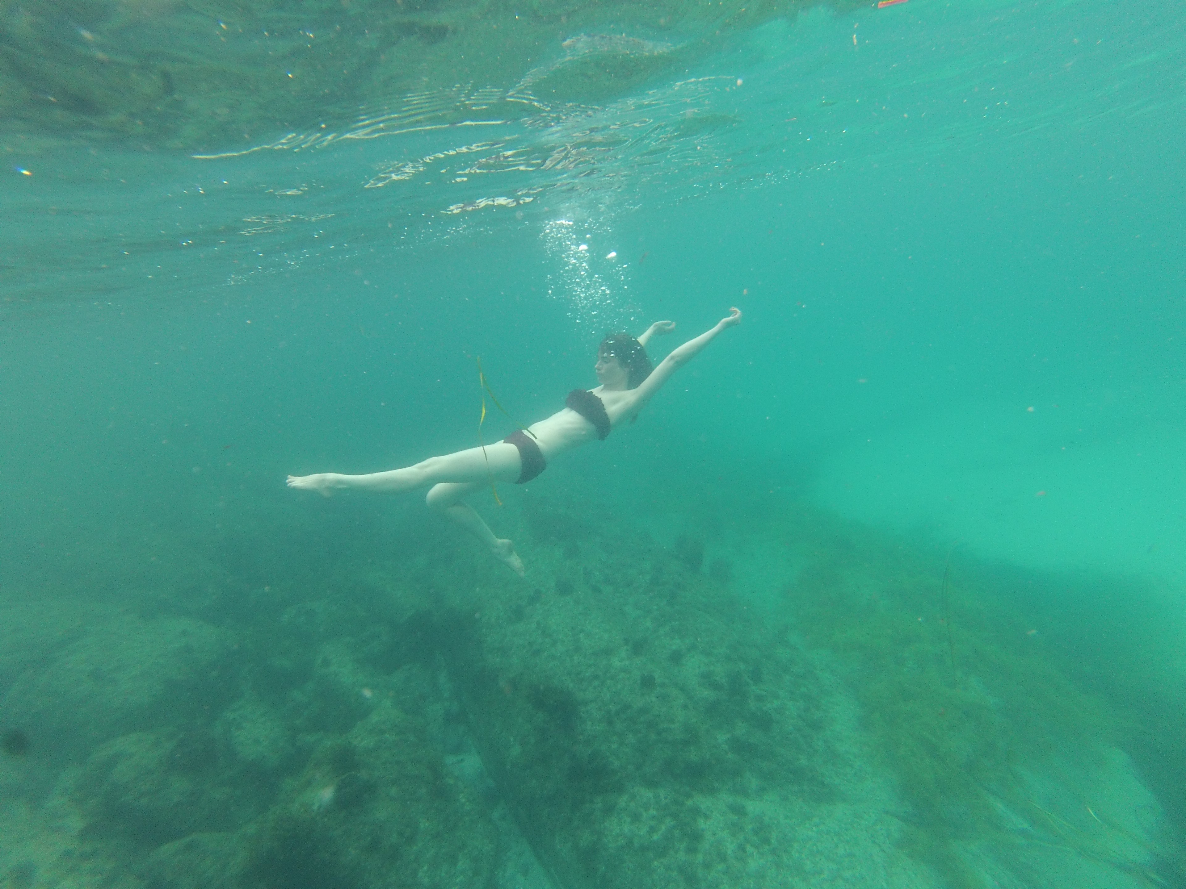 Woman swimming underwater.