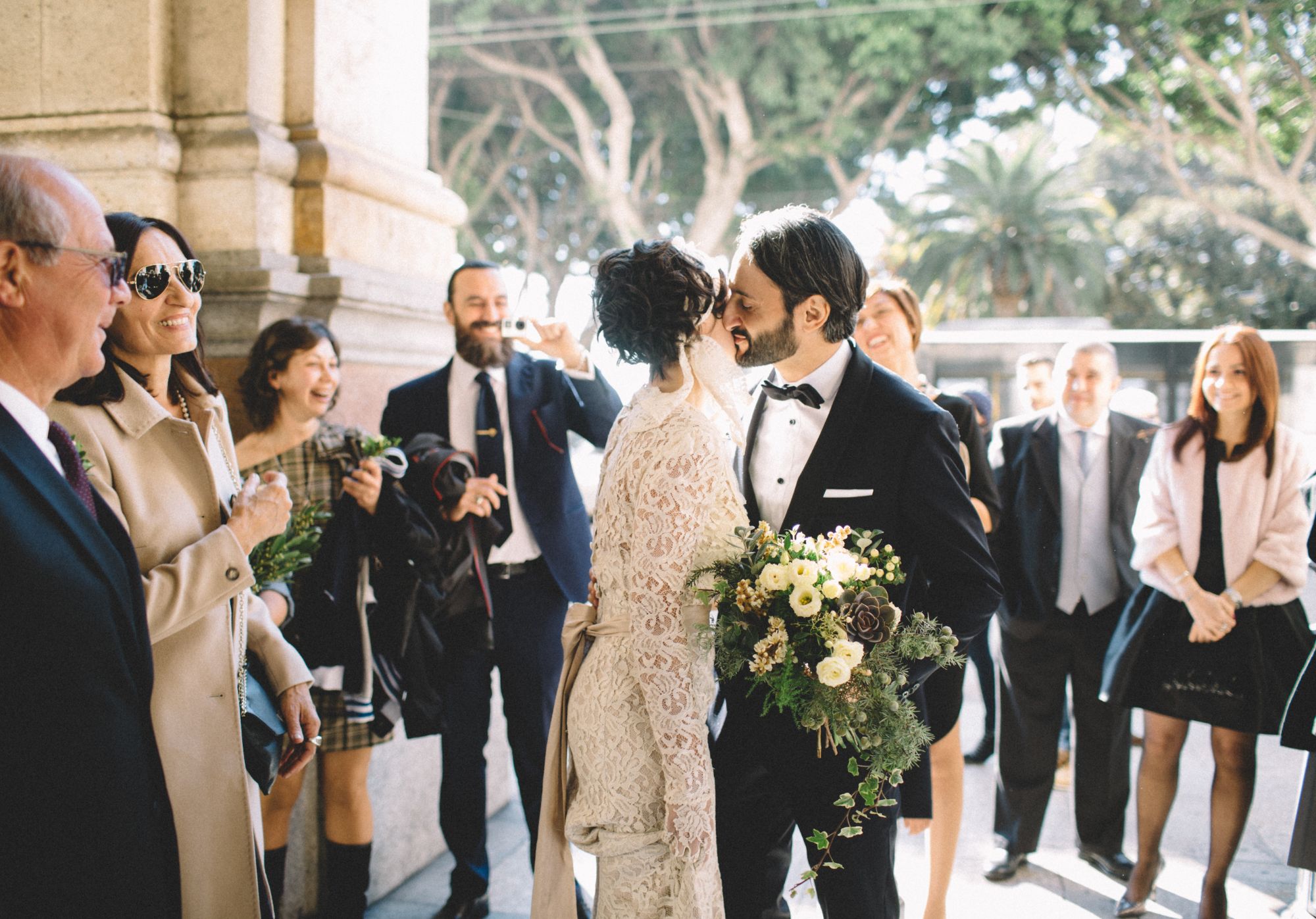 Newlywed couple surrounded by friends and family on their wedding day.