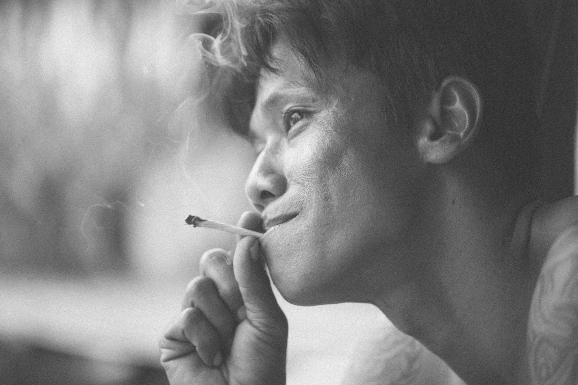 Thai man smoking cigarette.