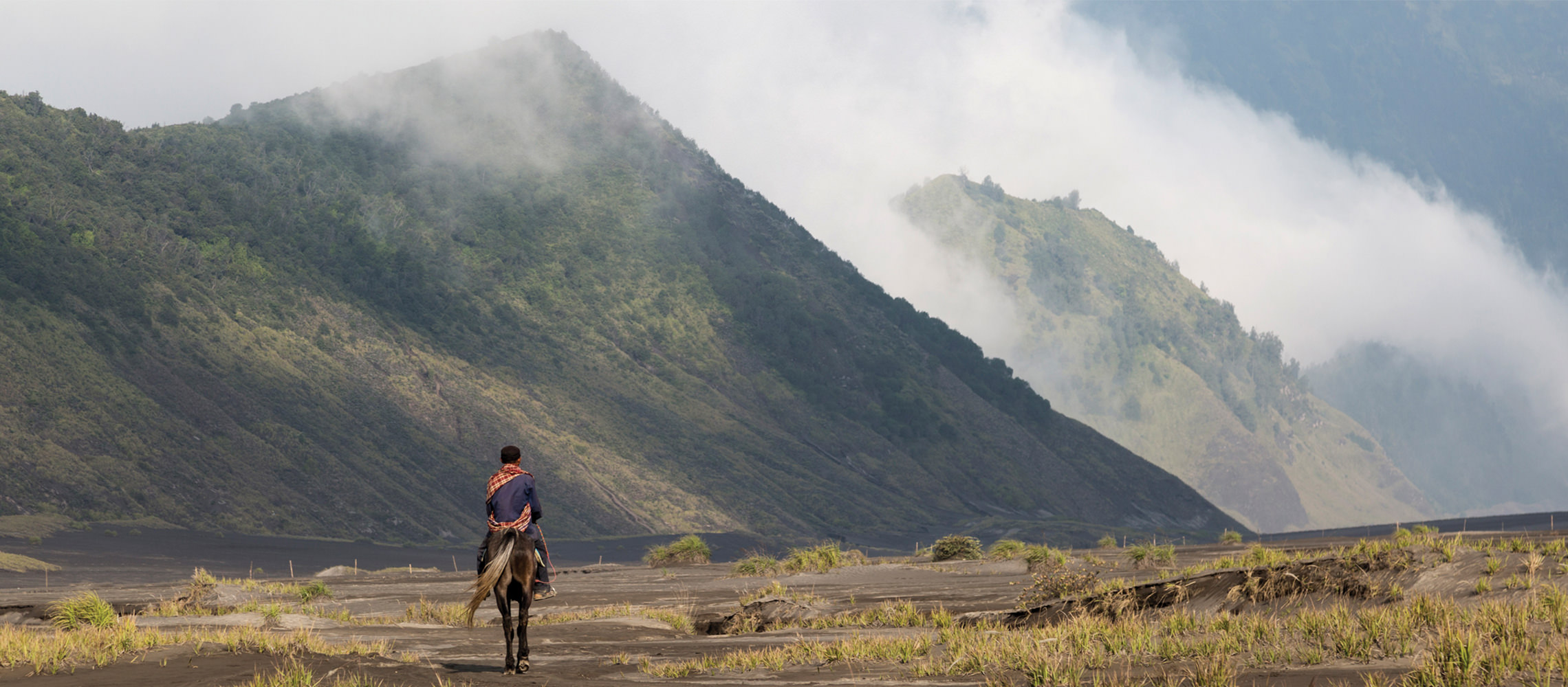 Person riding a horse in the mountains