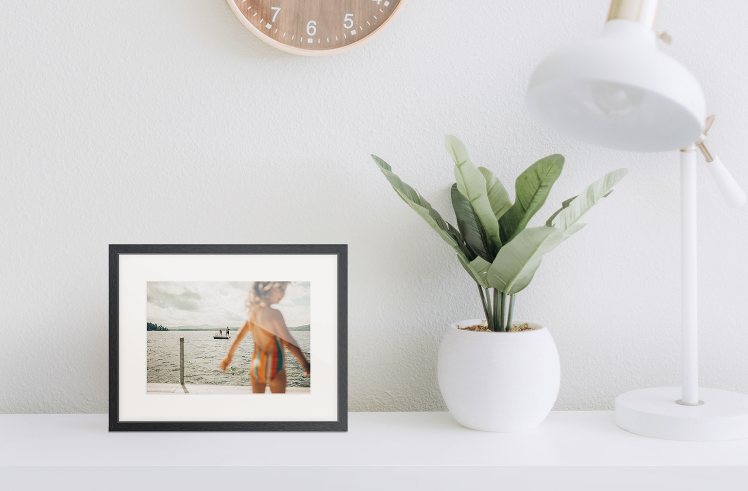 Gallery frame sitting on a side table.