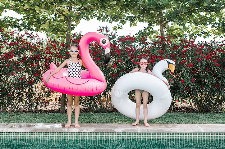 Two sisters with pool toys.