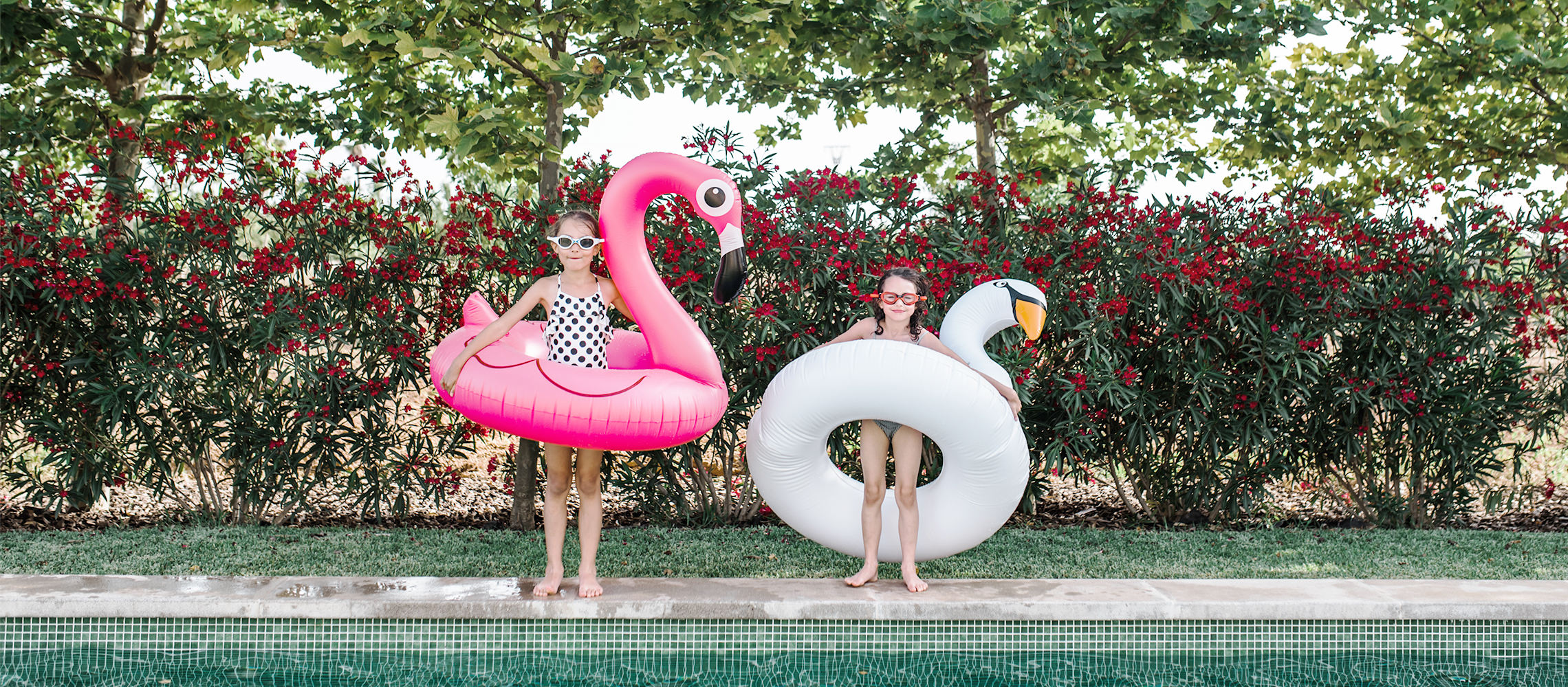 two sisters with pool toys