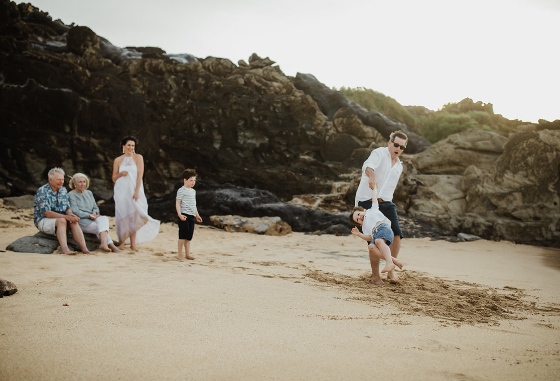 Family at the beach playing in the sand