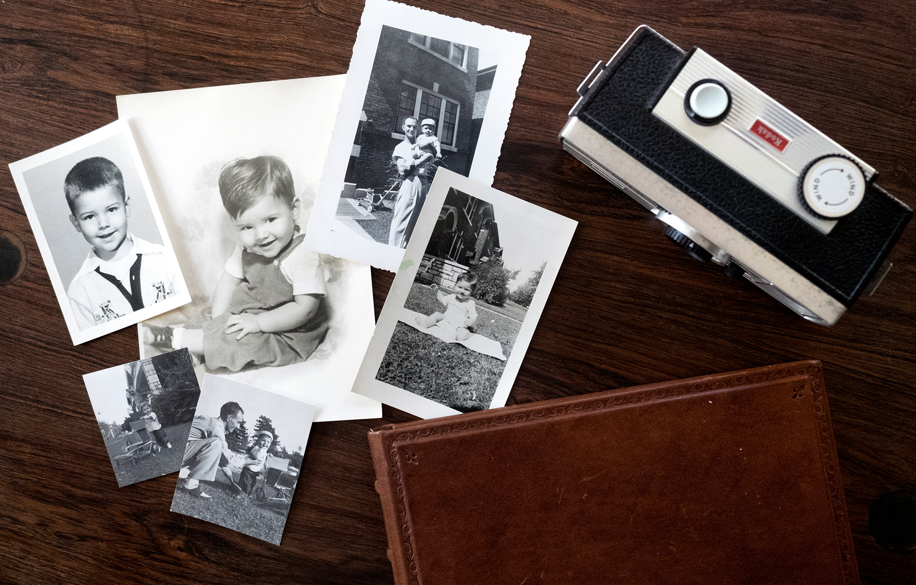Old photographs, leather photo album and camera.