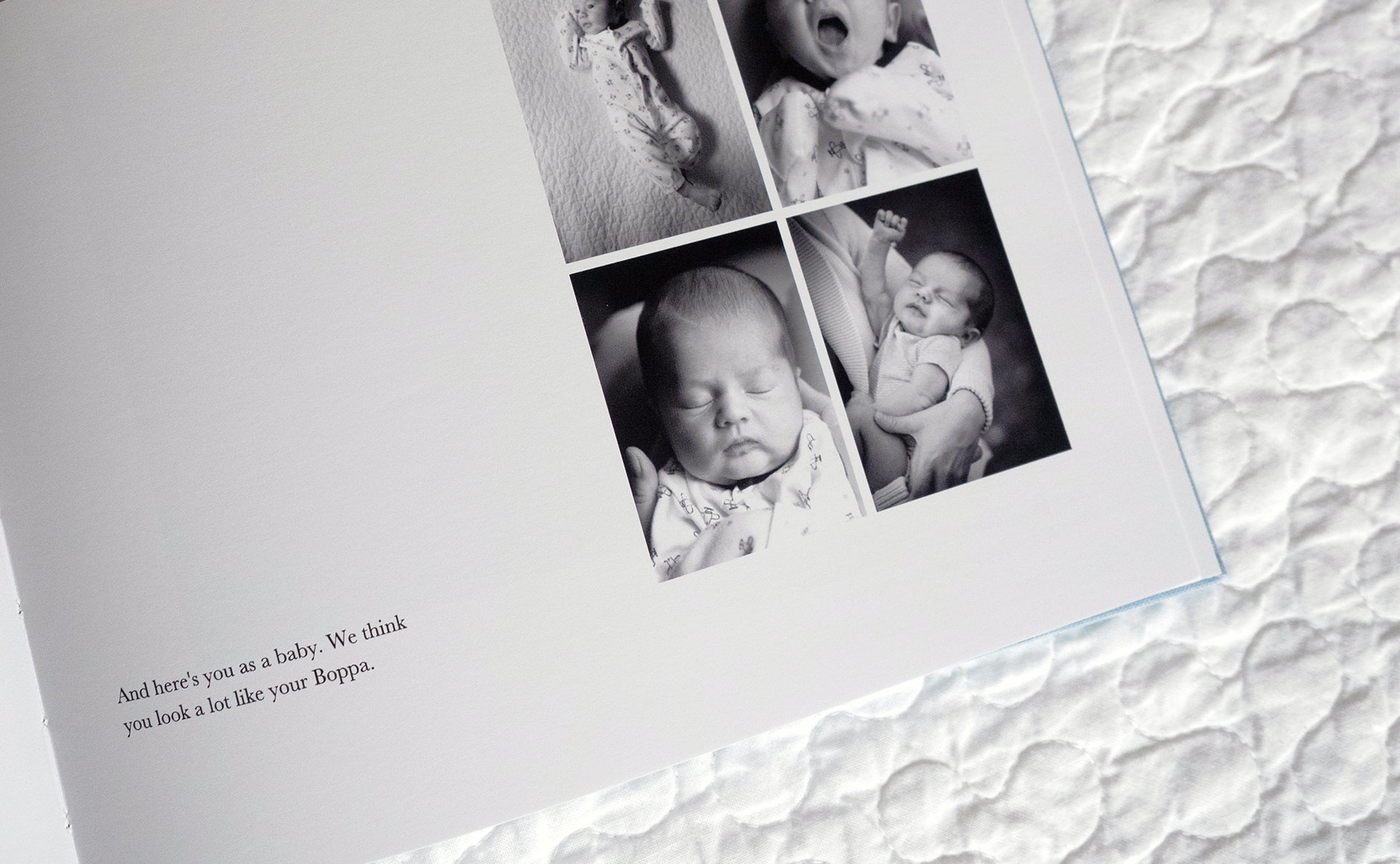 Photobook open on a bed,