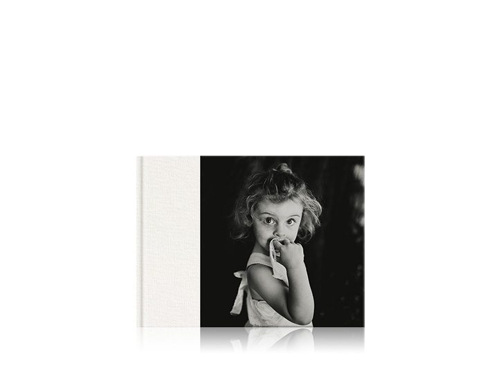 Landscape premium baby photo book with 3/4 cover of a young girl.