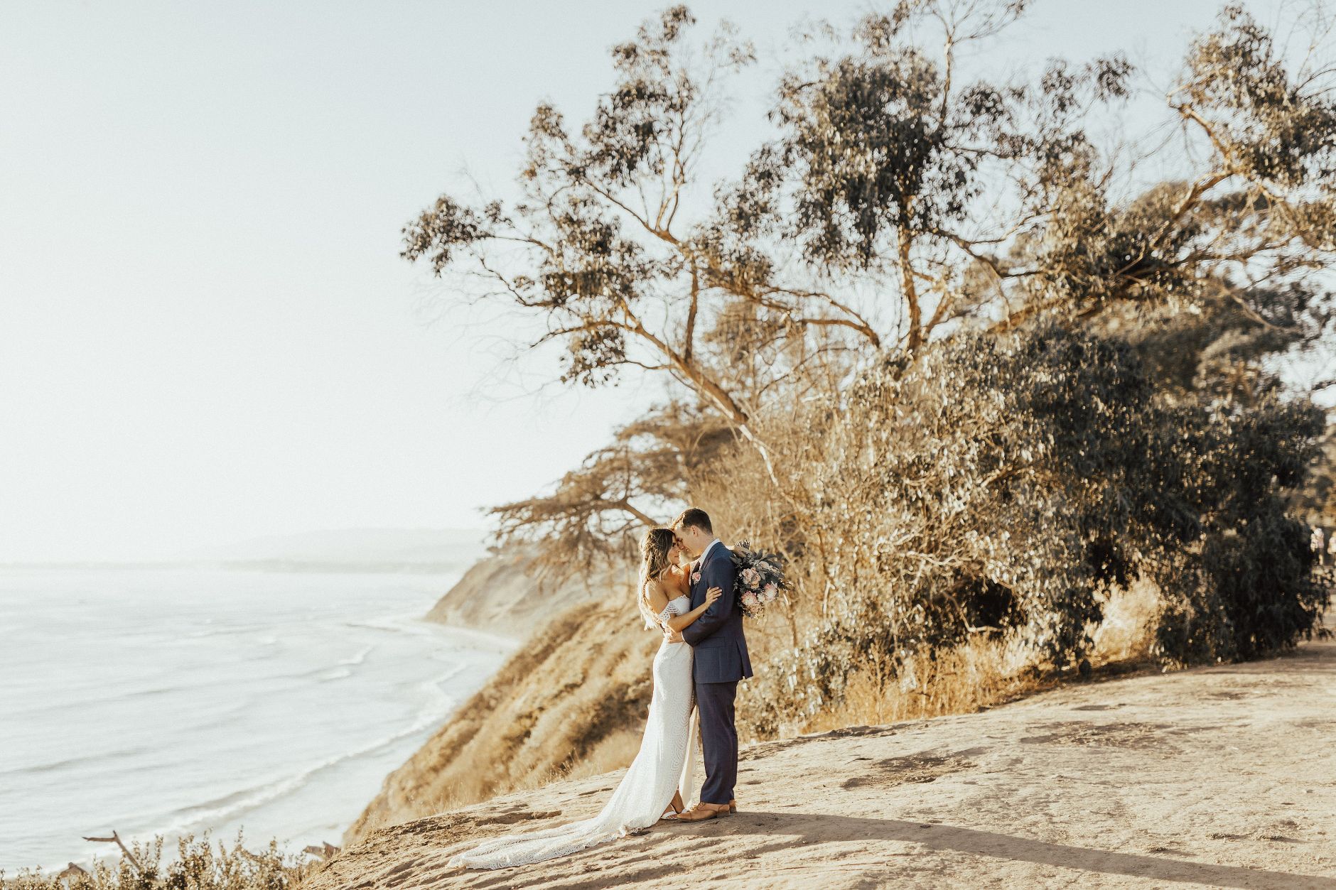 Bride and groom at cliffside.
