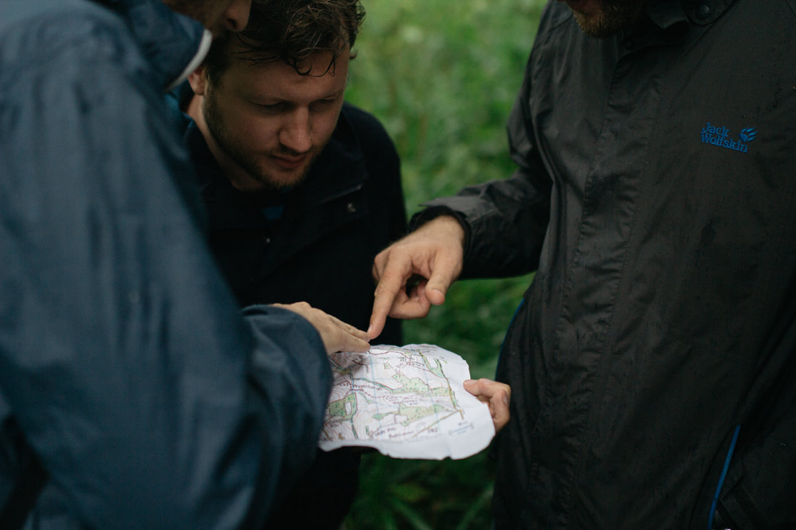 Three people looking at a map.