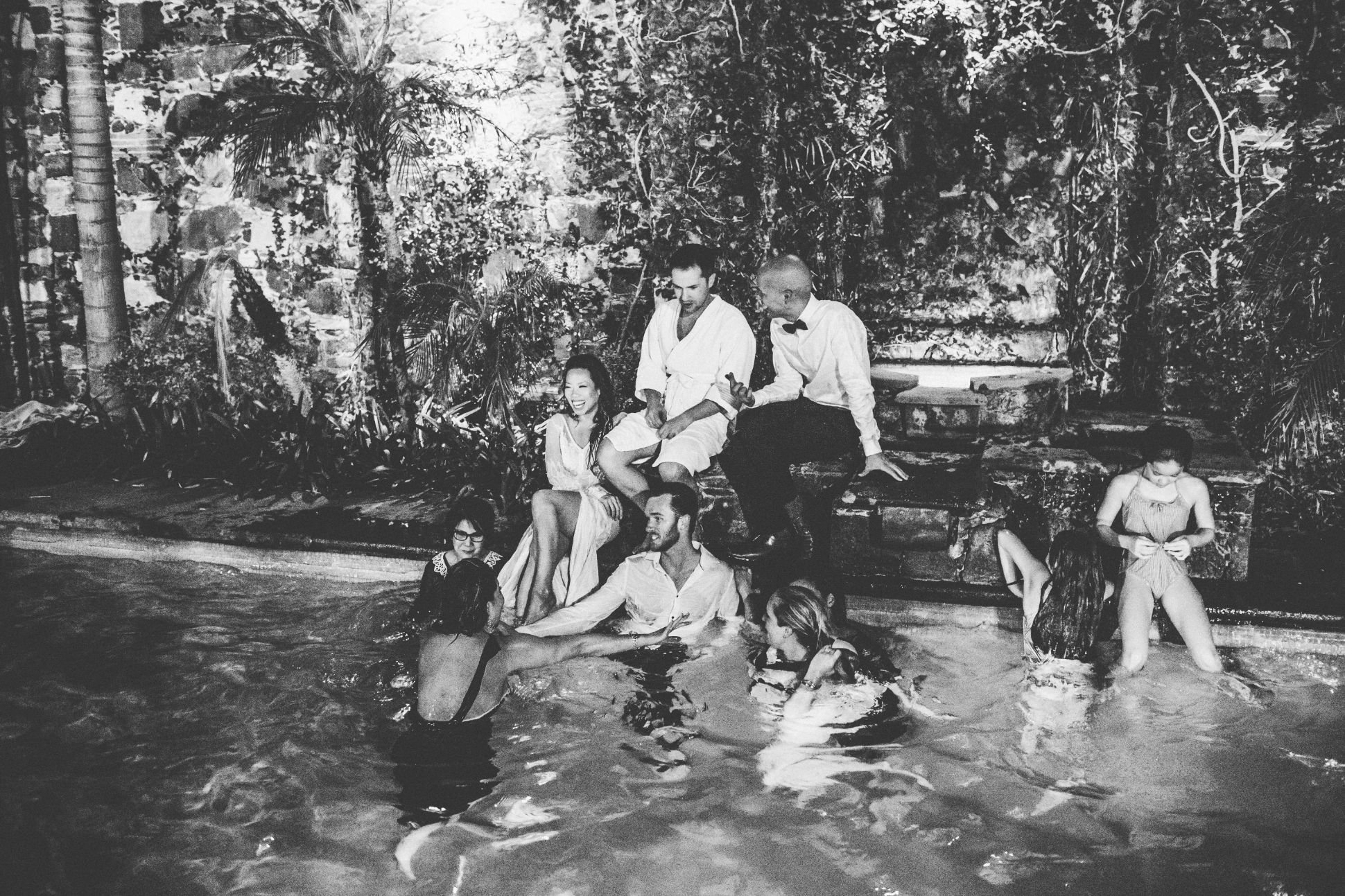 Bride, groom and guests in pool