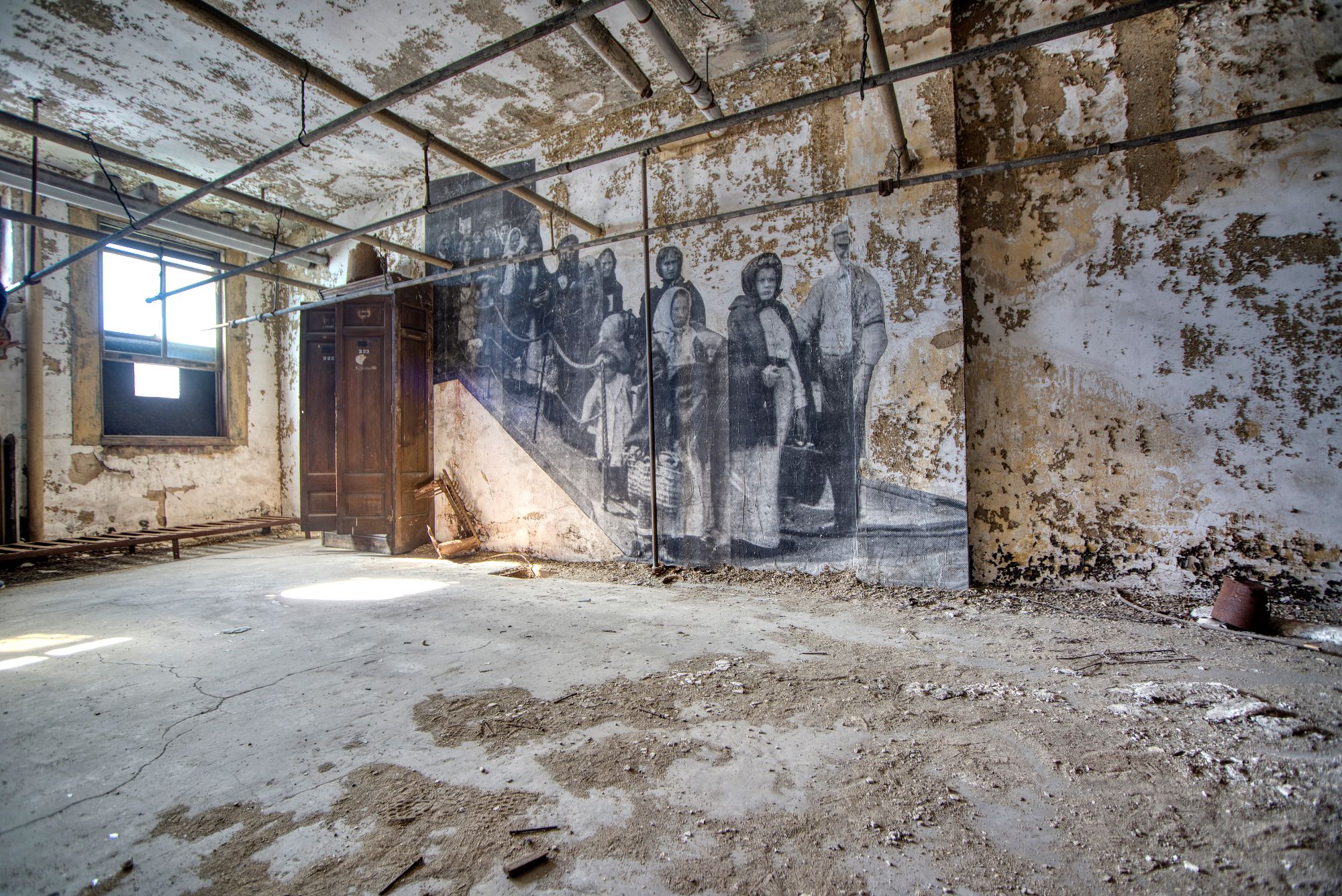 Derelict room with mural of immigrants at abandoned hospital on Ellis Island