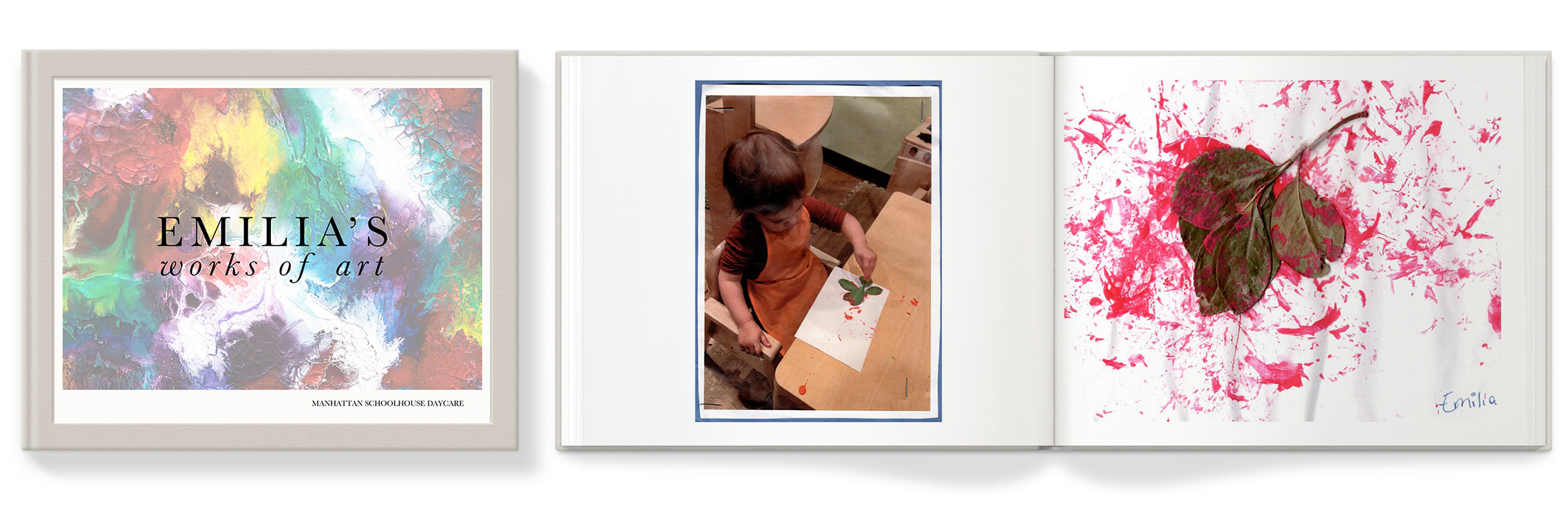 Closed photo book and open photo book with images of a child's artwork.