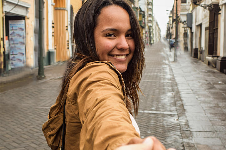 Woman smiling at camera in cobbled street