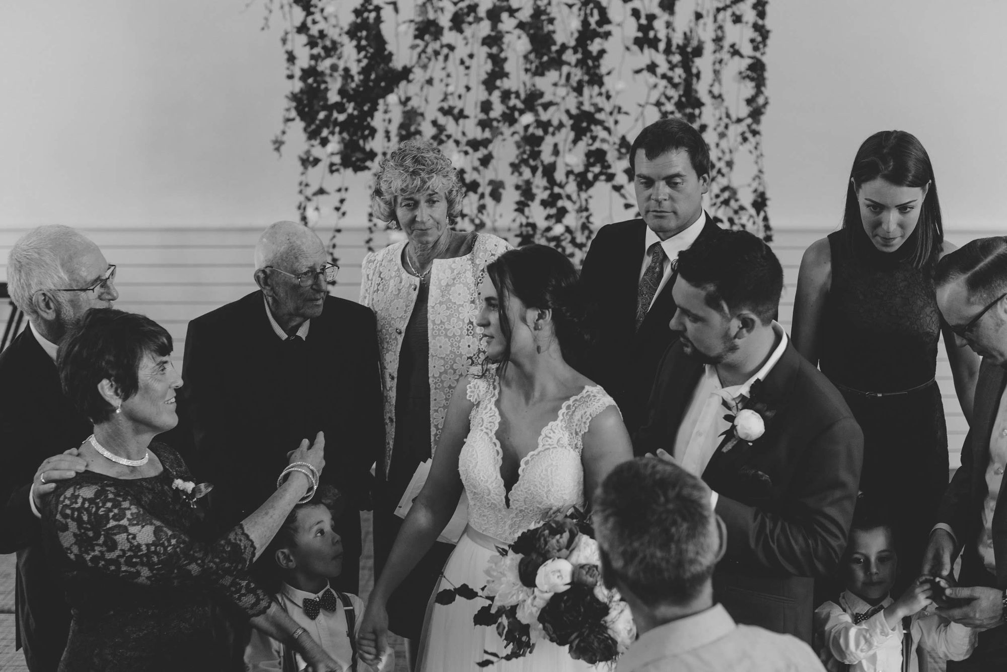 Newlyweds and family getting ready for photo