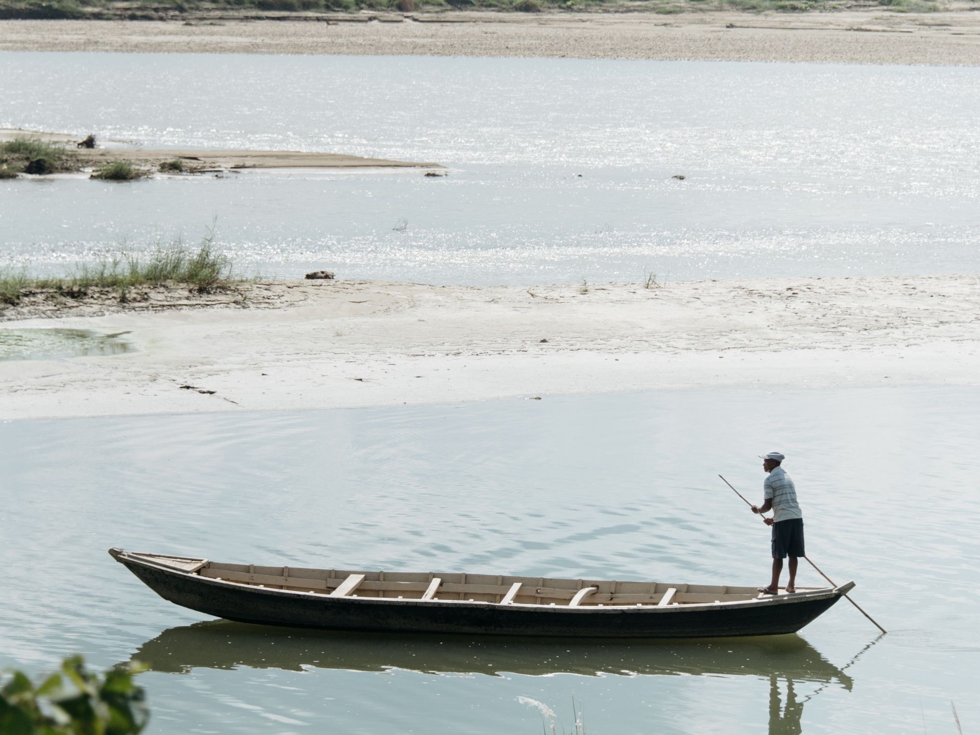 Man on canoe on still water