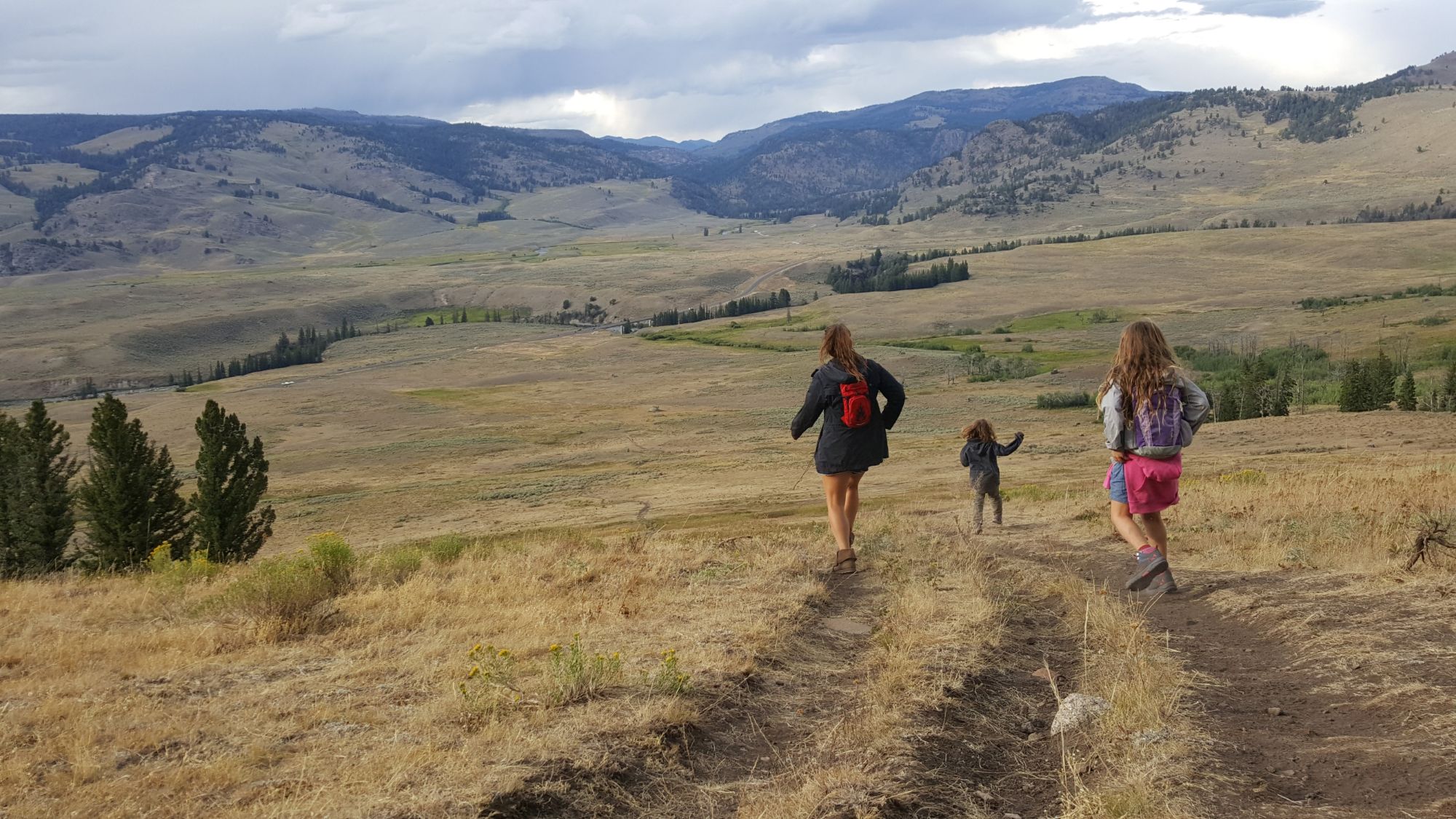 Mother and two children walking along path