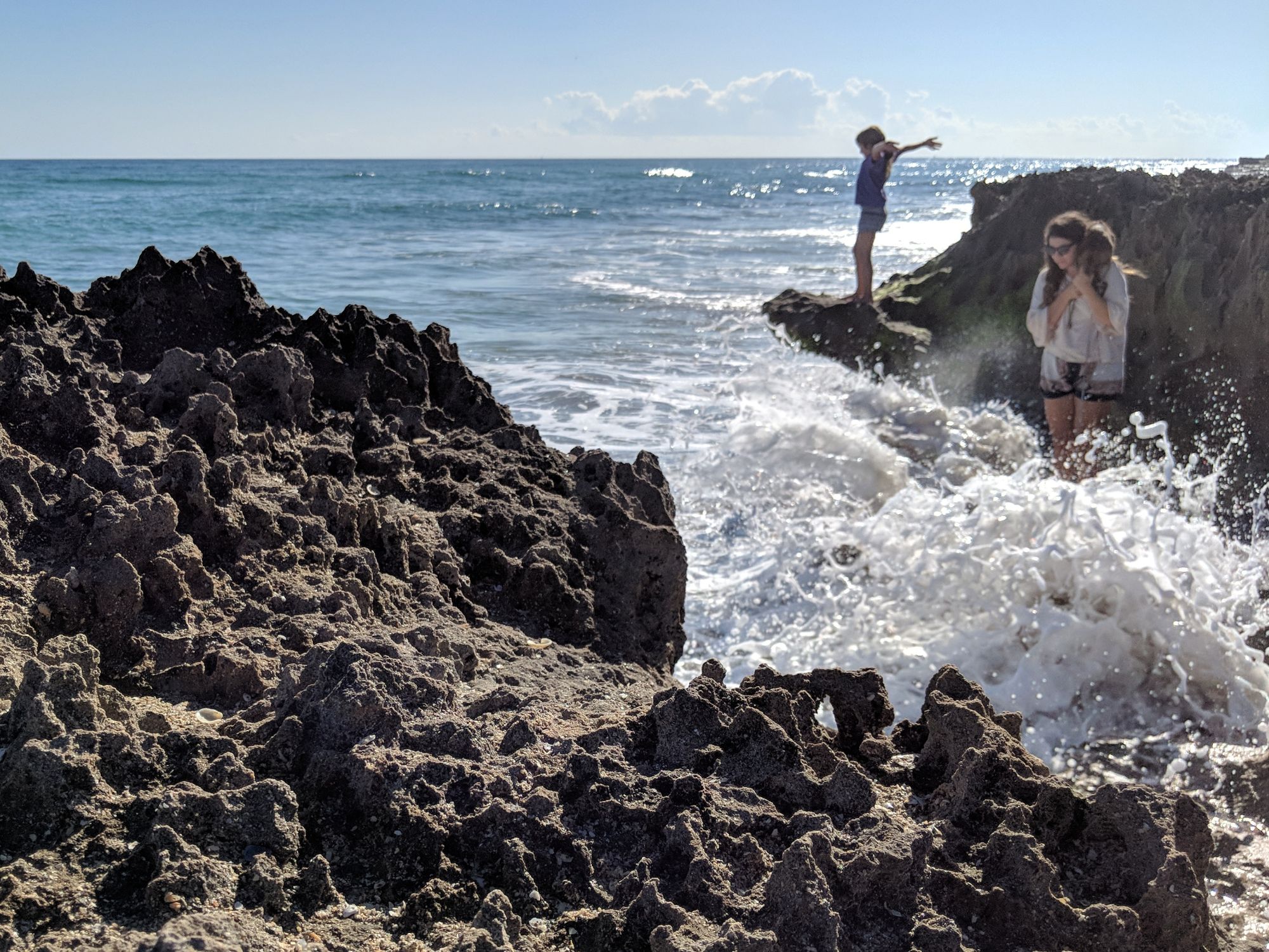 Woman with cat and child by the sea