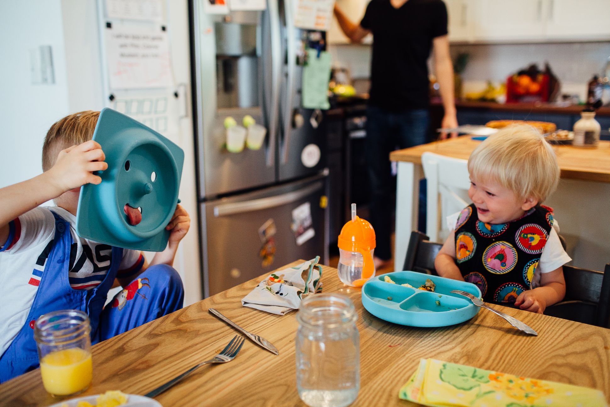 Siblings eating breakfast and laughing