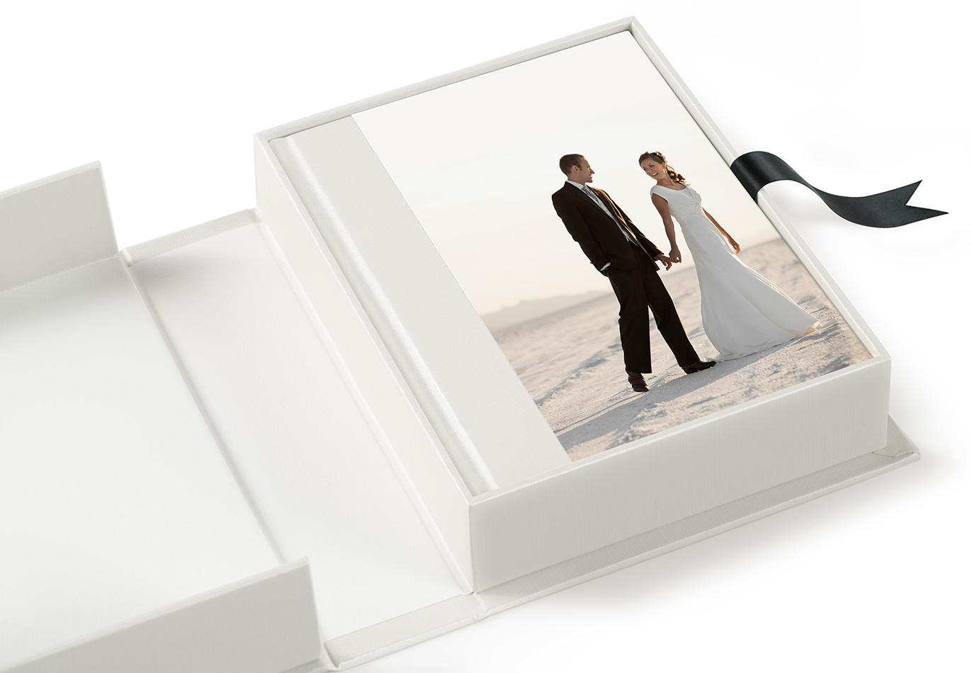 An open MILK presentation box on a white background with a photo album featuring a portrait of a bride and groom on their wedding day on the cover.