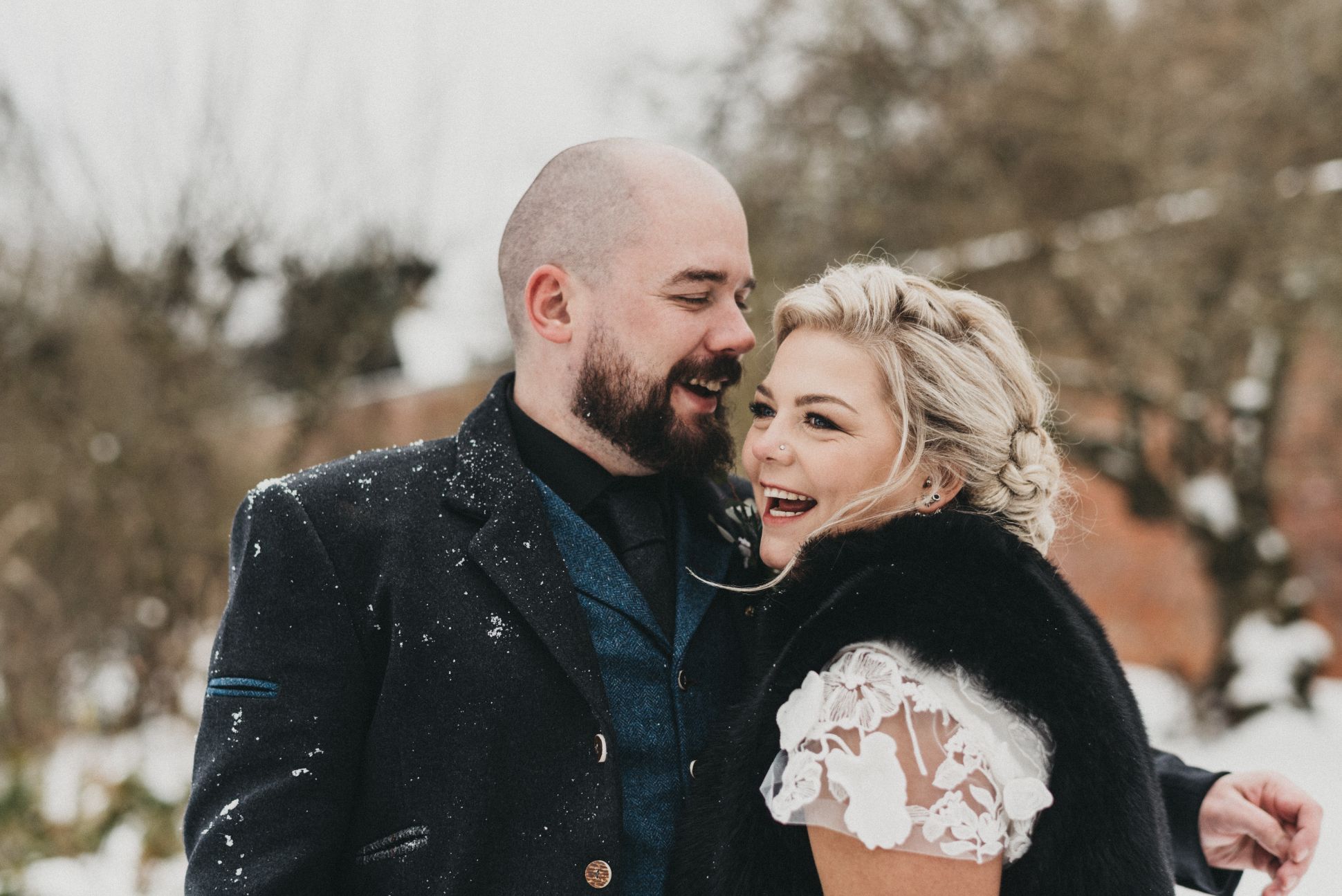 Newlyweds smiling in snow