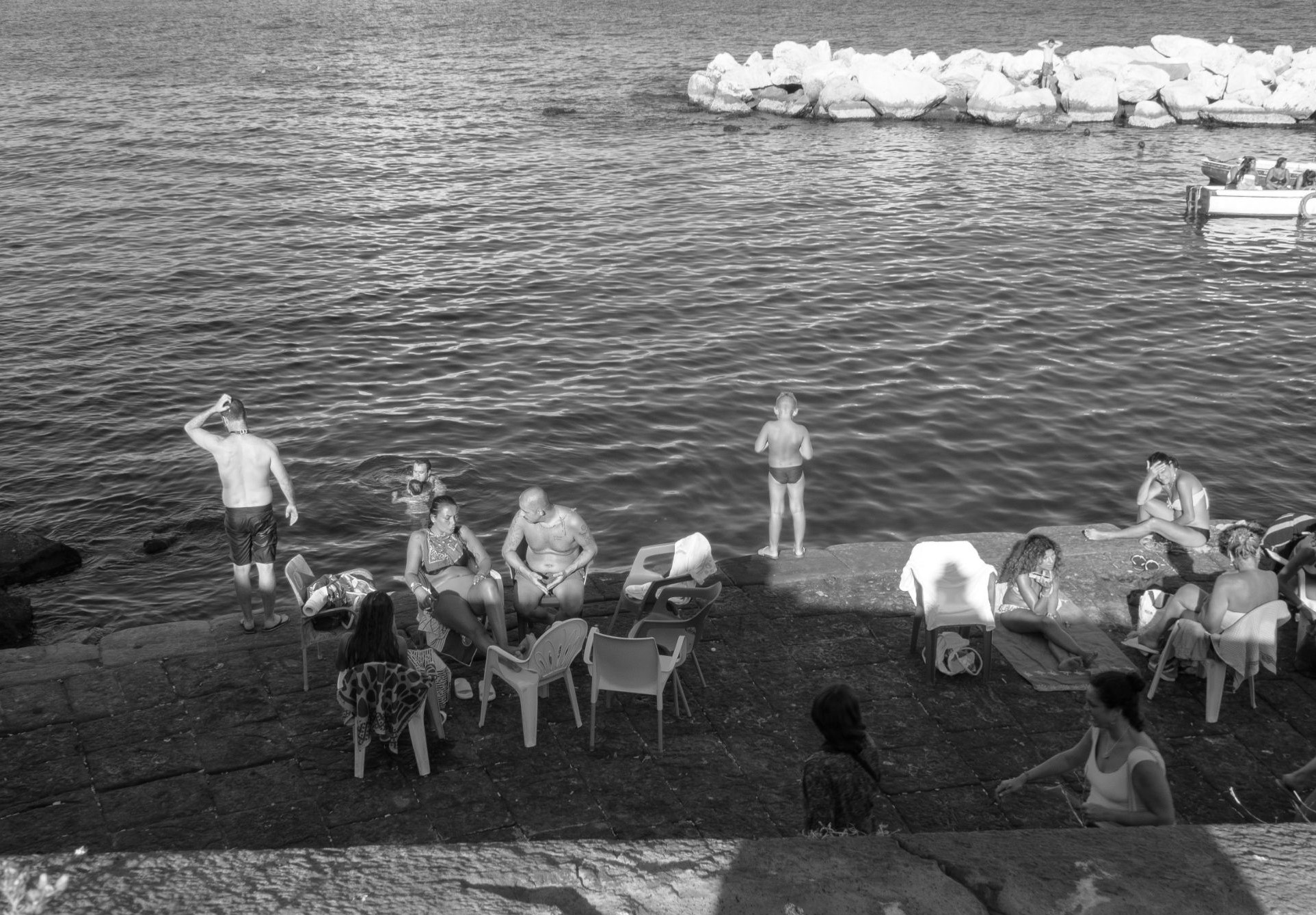 People on pier, Naples, Italy