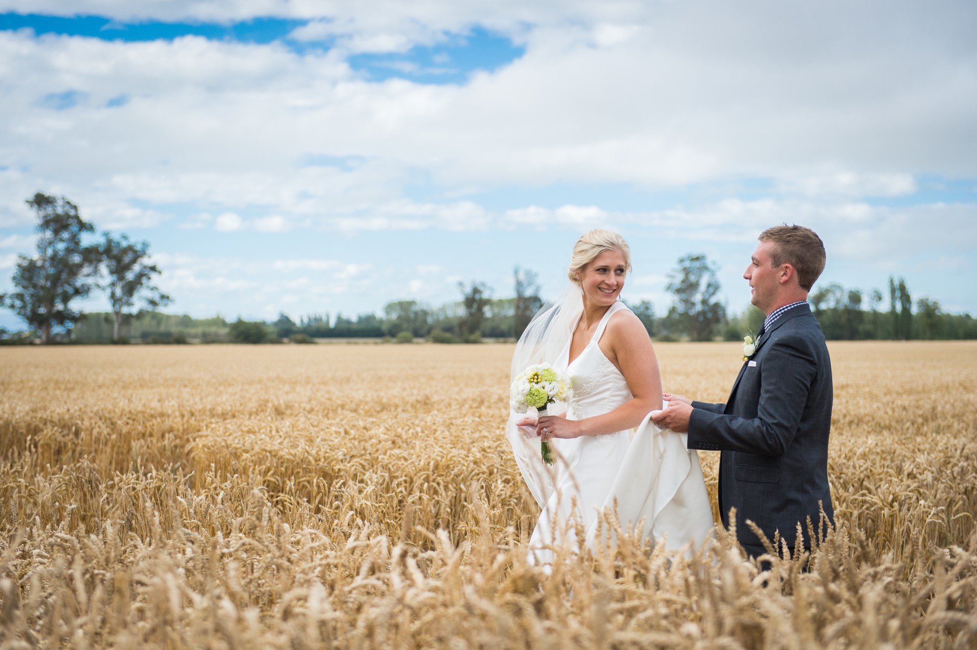 Bride and groom in open field