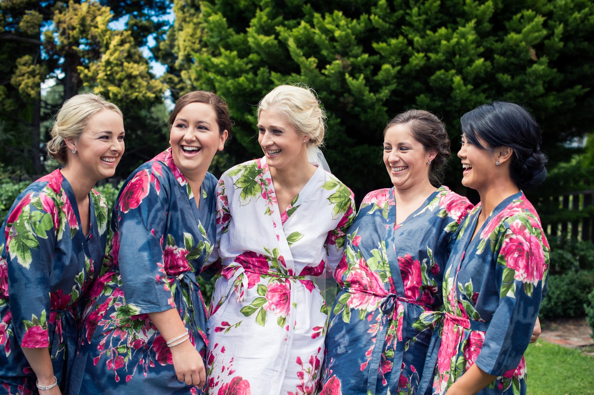 Bride laughing with her bridesmaids