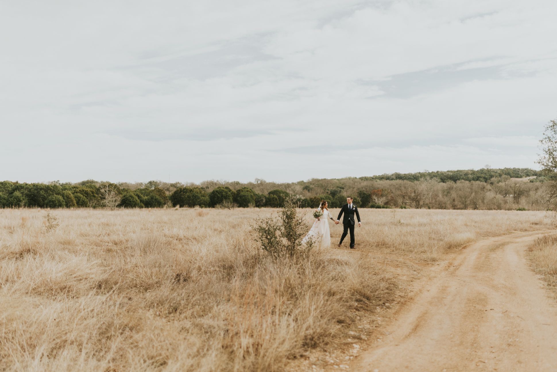 Newlyweds together in open field
