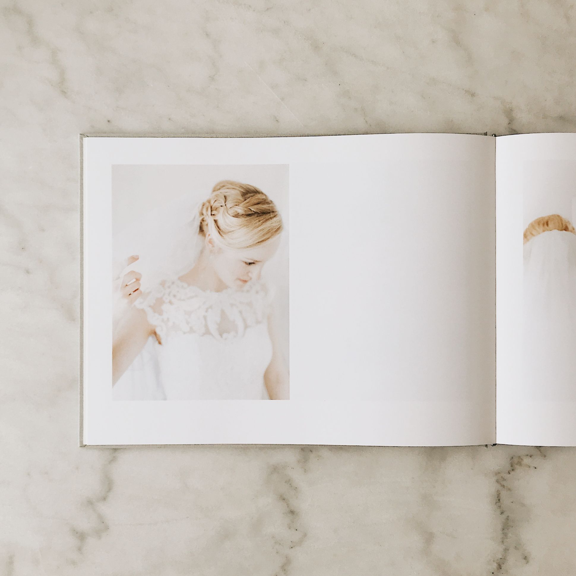 Wedding book open to photo spread of bride