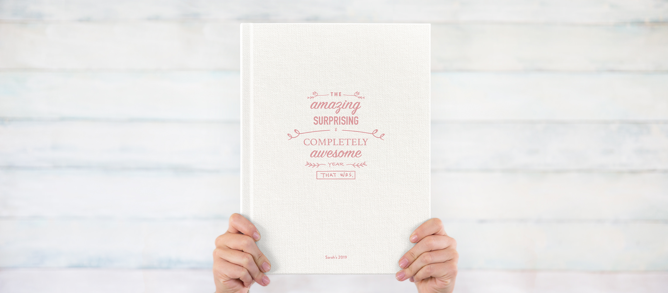 Photo book with UV cover text 'the amazing surprising and completely awesome year that was'.