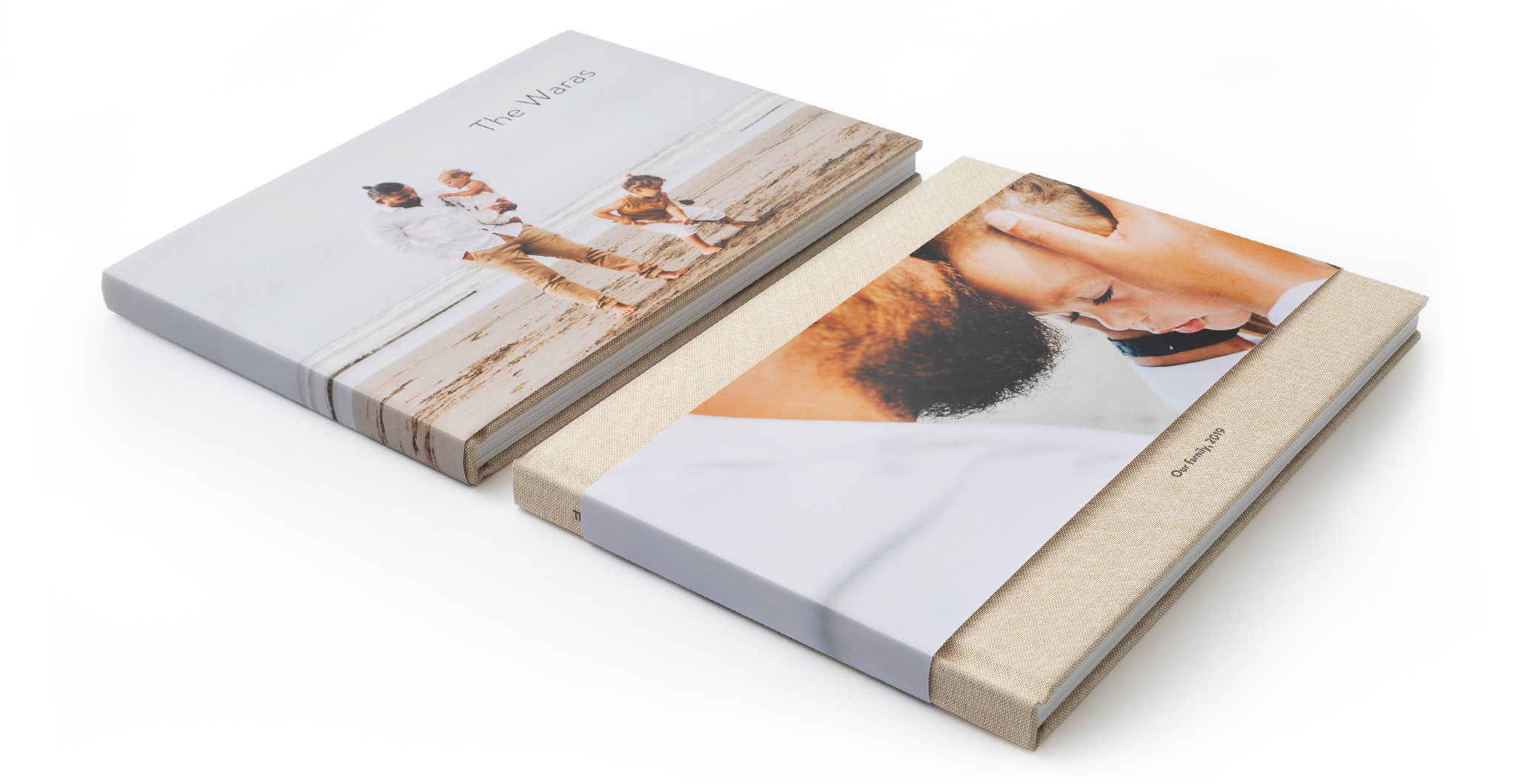 Two flat lay premium photo books; one with a full MILK jacket, one with a partial MILK jacket.