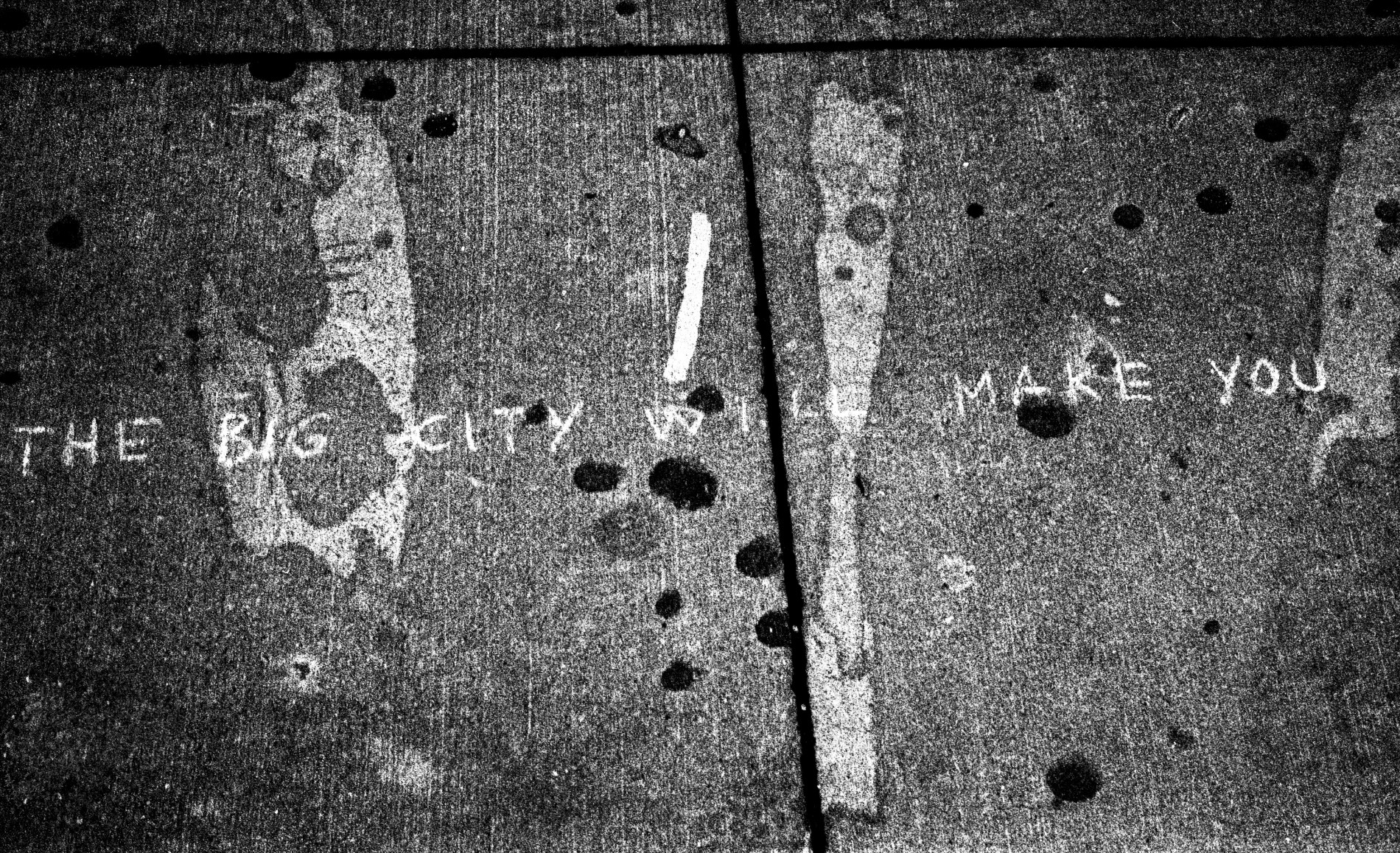Concrete footpath with THE BIG CITY WILL MAKE YOU written atop.