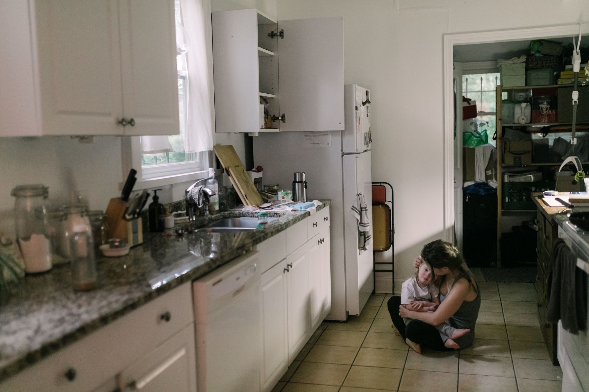 Mother and daughter on the floor of the kitchen.