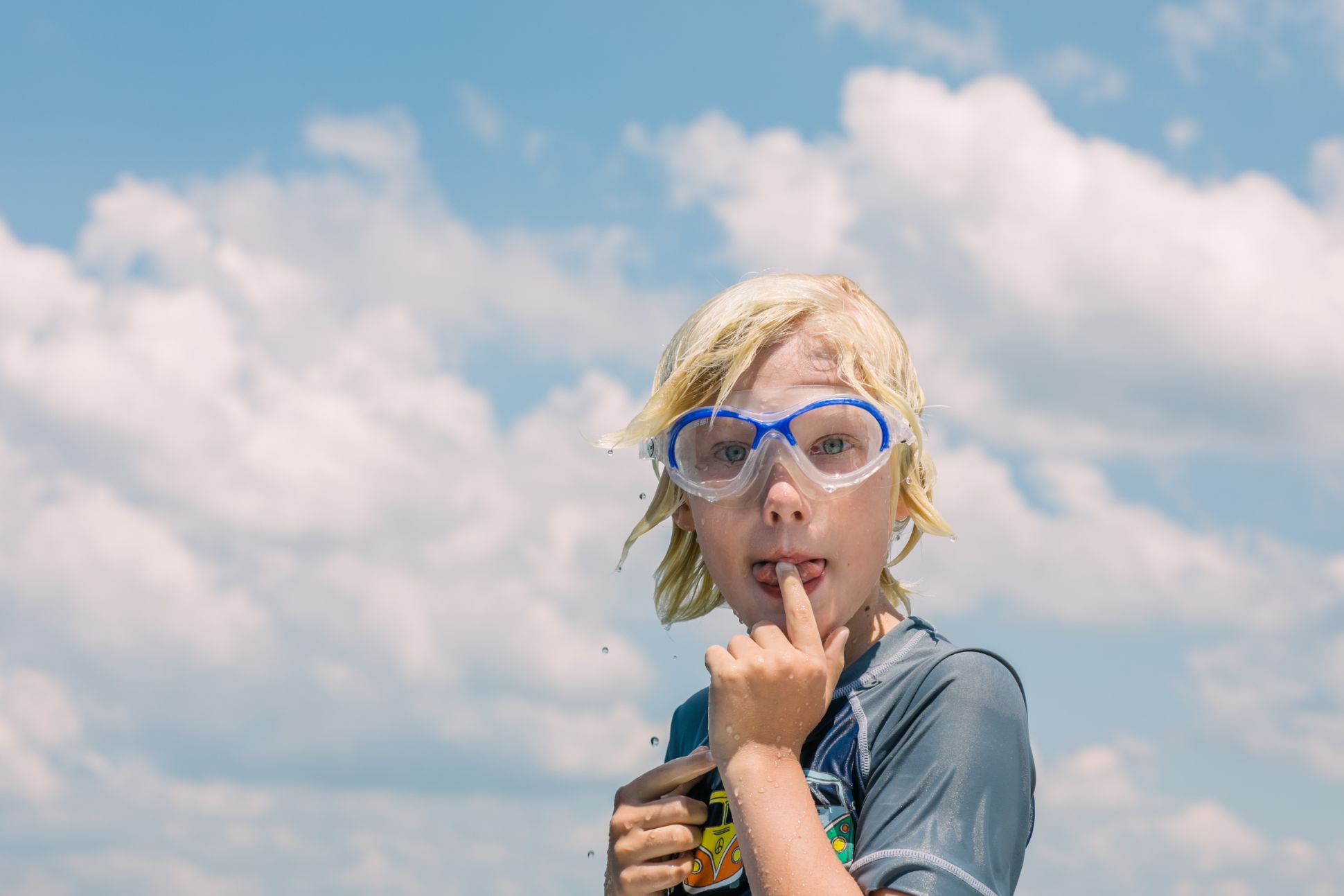 Blonde child in swimming goggles.
