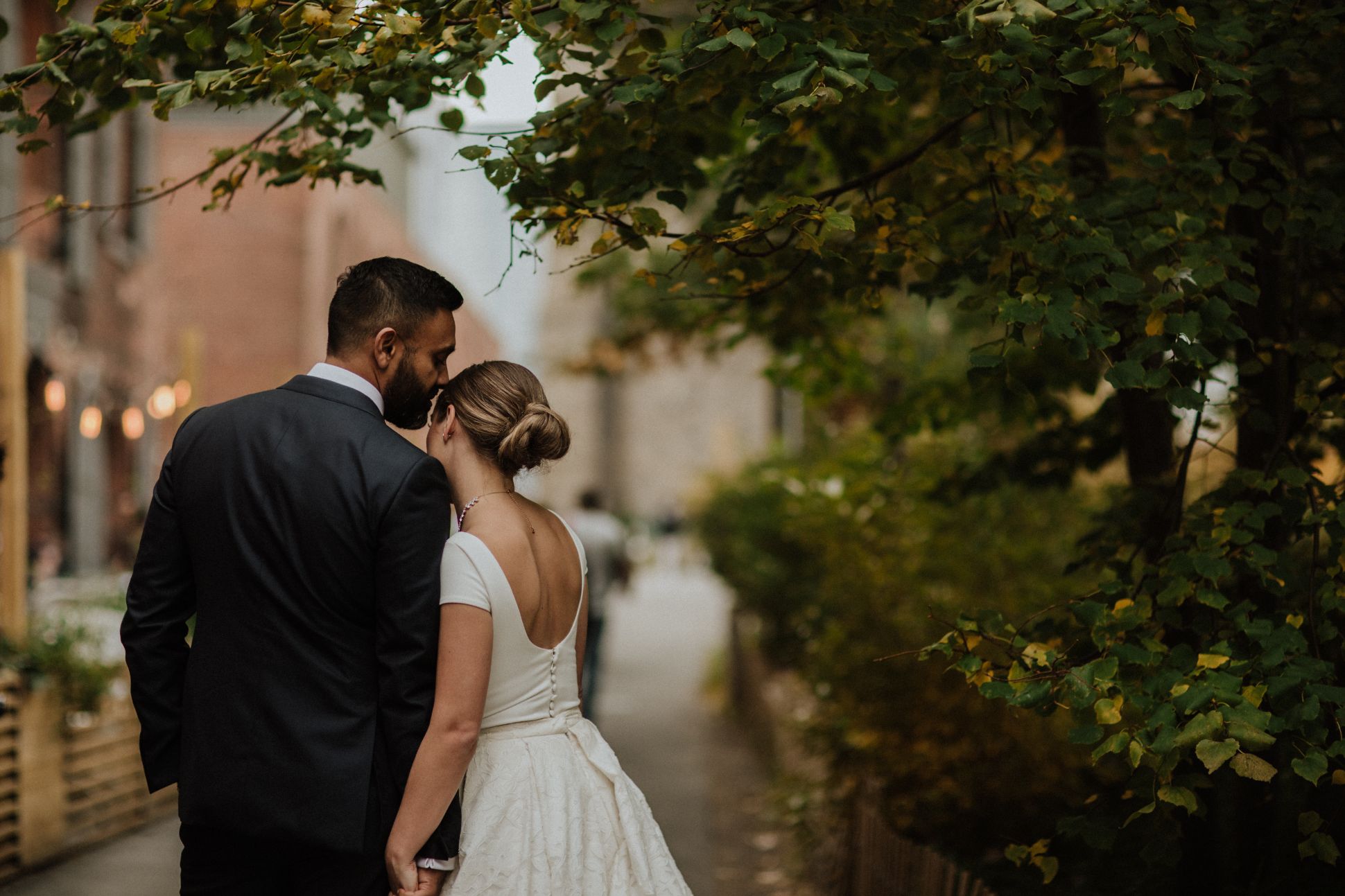 Bride and groom walk together along New York street