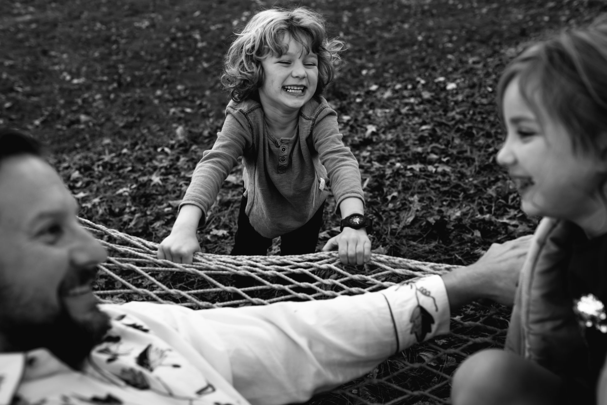 Father and his two children playing outside.