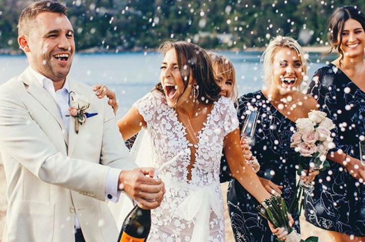Newlyweds celebrating with wedding party